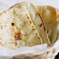 Butter Naan · Delicious and supple leavened white bread made with refined white
flour, baked in tandoor ov...