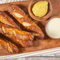 Bavarian Pretzels · Four lightly salted pretzel sticks served with queso dip and spicy mustard.
