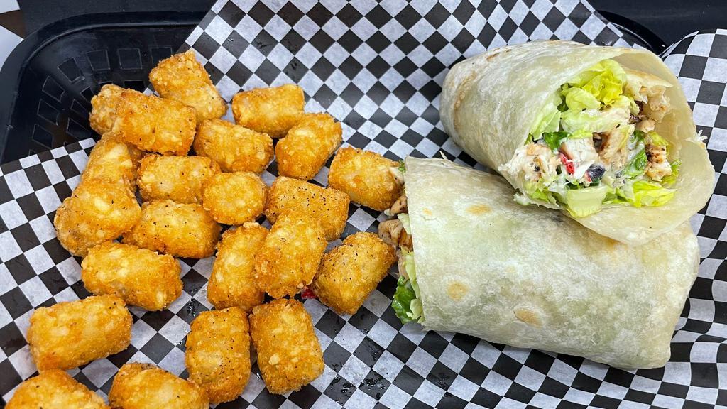 Chicken Caesar Wrap · Grilled chicken, romaine lettuce, tomato, red onion, tortilla strips, and caesar dressing wrapped in a flour tortilla. Served with fries.