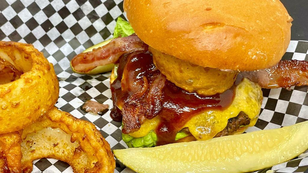Western Bbq Burger · BBQ, Cheddar, sliced bacon, onion ring, lettuce, and tomato. Served with fries.