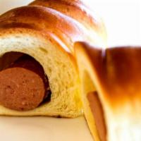 Sausage In Dough Baked · Handcrafted dough made with smoked sausage.