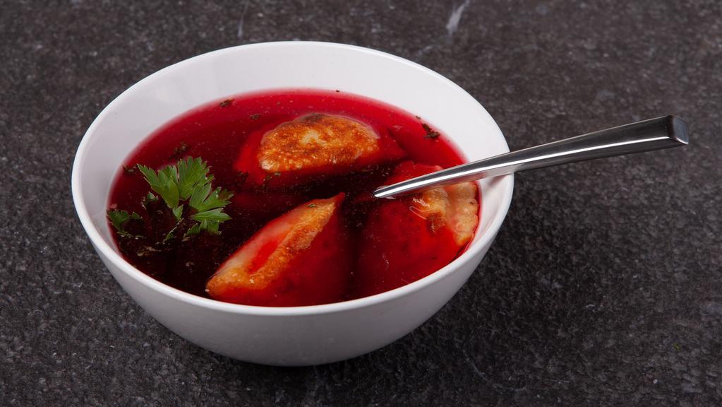 Red Borscht  · Classic beetroot soup, served with three pork or three sauerkraut mushroom pierogies.