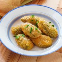 Jalapeño Poppers (4 Pcs) · Hot jalapeños stuffed with cheese. Lightly breaded and melty on the inside.