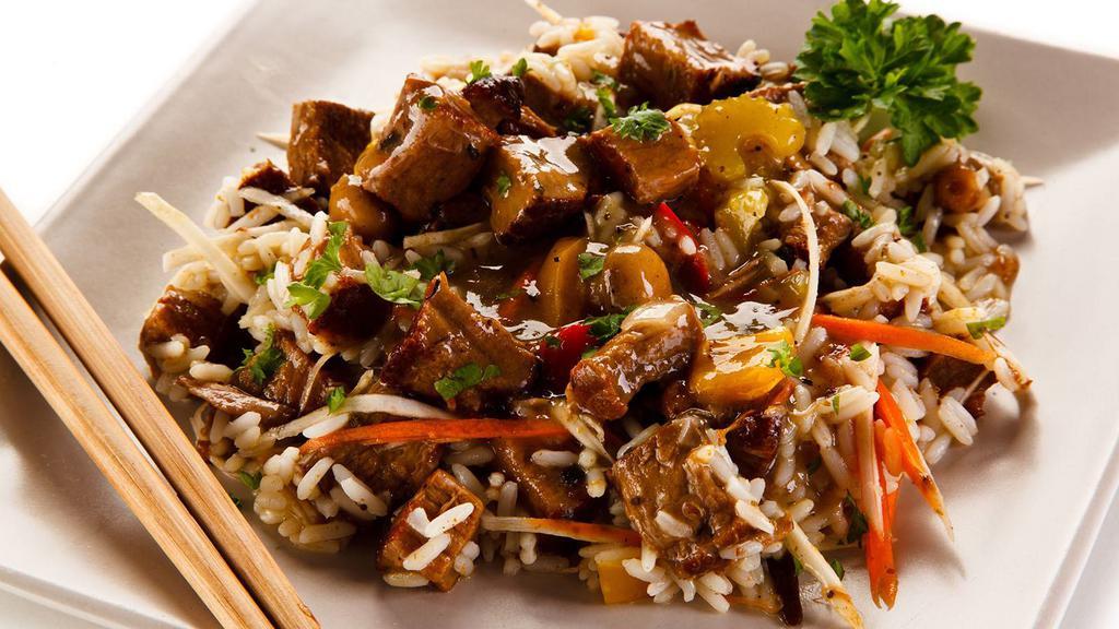 Beef Fried Rice · Traditional dish of tender strips of sirloin, vegetables, eggs, crisp rice, and a rich, full-flavored sauce.