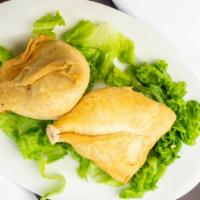 Vegetable Samosa · Crispy pastries stuffed with potatoes, and peas lightly seasoned with spices.