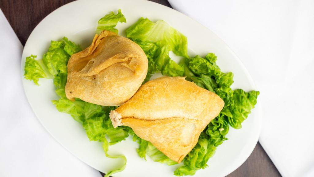 Vegetable Samosa · Crispy pastries stuffed with potatoes, and peas lightly seasoned with spices.