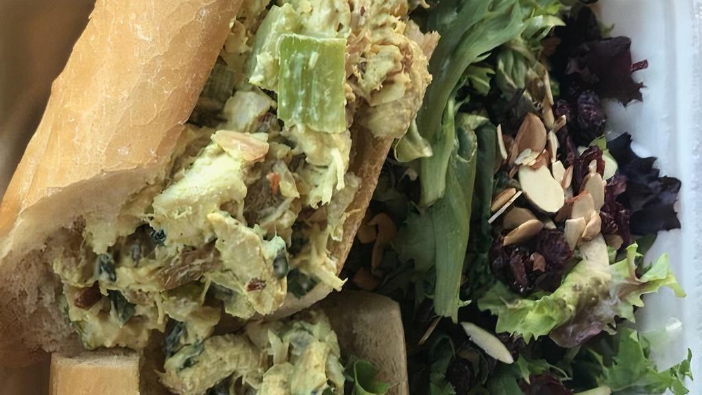 Curry Chicken Salad Sandwich · Shredded chicken breast, pineapple, golden raisins, almonds, celery and curry mayo with baby greens on a baguette.