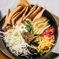 Quinoa Bowl · Black beans, avocado, cheddar, cabbage, green onions, tomatoes, salsa, sour cream, with tort...