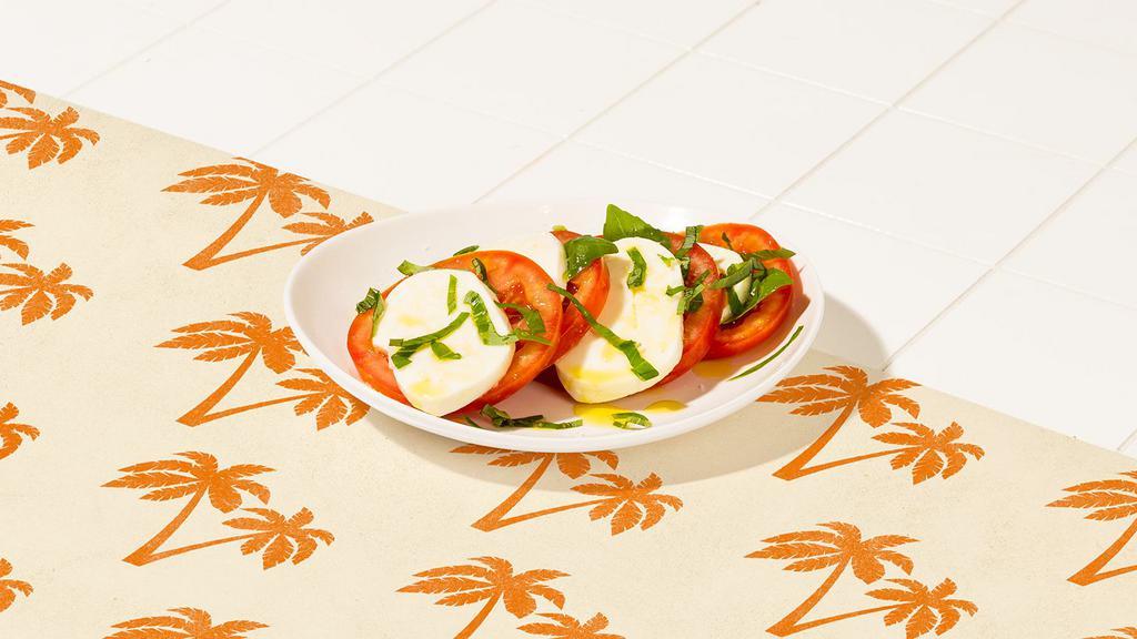 Caprese Salad · Sliced tomato, fresh mozzarella, and basil with balsamic.
