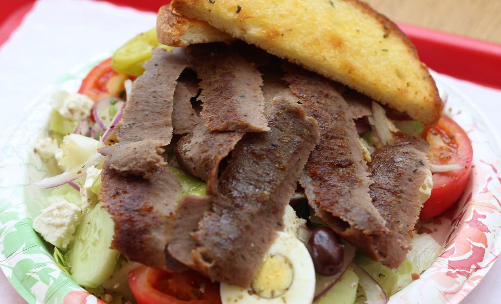 Gyro Greek Salad · Gyro Meat, Lettuce, Tomatoes, Cucumbers, Boiled Egg, Olives, Red Onions, Pepperoncini, Feta Cheese, & Garlic Toast