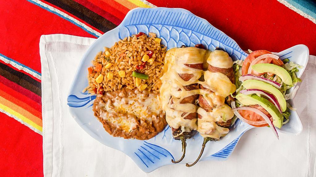 Chiles Crossroads · Two anaheim green peppers stuffed with shrimp ranchero, wrapped with bacon and  topped with cheese, served with rice and beans and tortillas.