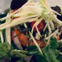 Grilled Salmon Salad · Mixed green salad, grilled salmon, cherry tomato, Thai herbs with chili lime dressing.