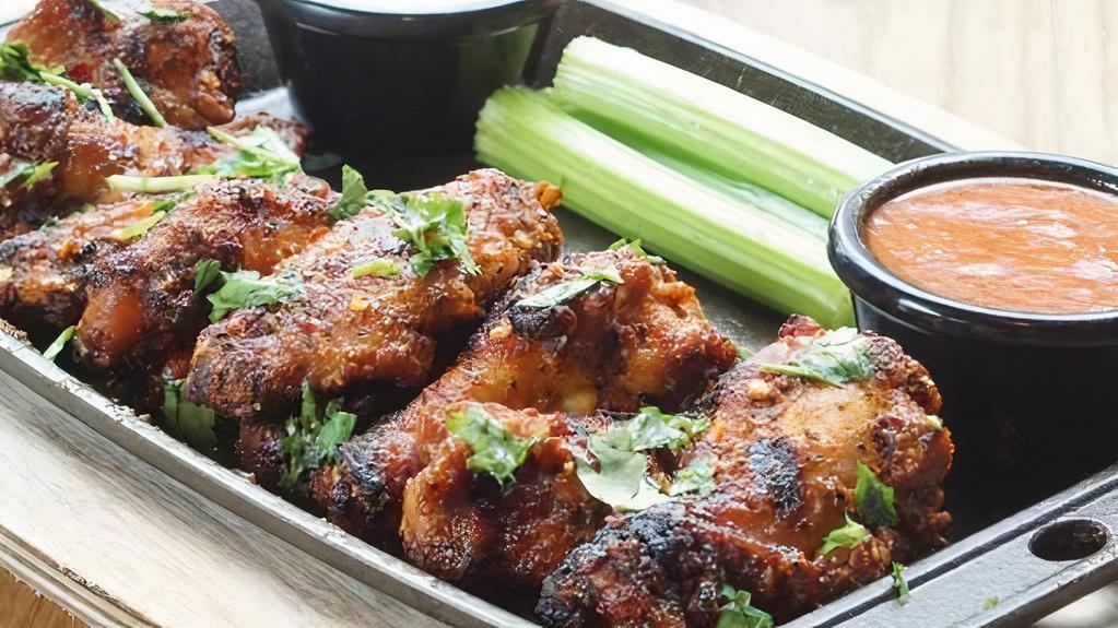Lemon Pepper Wings · Full pound of spicy marinated grilled wings tossed with lemon pepper sauce served with ranch or blue cheese dressing. Spicy Hot, Gluten-free.