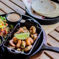 Flaming Shrimp Tacos · Chipotle lime marinated shrimp served on a sizzling skillet with shredded cabbage, Serrano a...