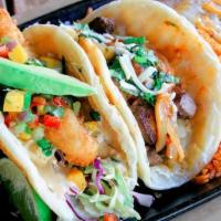 Surf & Turf Taco Combo · Beer battered lobster taco and grilled filet mignon taco. Served with Mexican rice and refri...