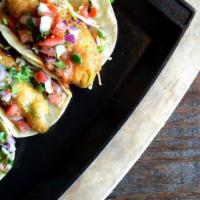 Vegan Crispy Avocado Street Taco · Three mini corn tortillas filled with crispy beer battered avocado, cabbage slaw, roasted ch...