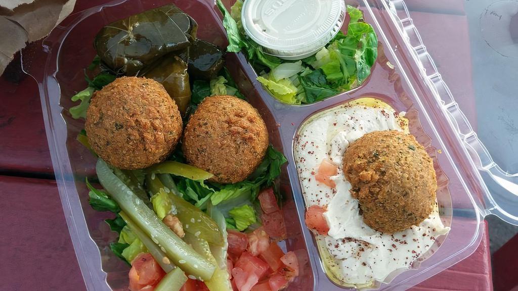 Falafel Over Salad · 4 Vegetarian. Deep fried vegetable patties made with chickpeas and spices. Served over green salad serve with Tahini sauce side