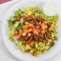Beef Shawarma Over Salad · Marinated and seasoned beef grilled served over mixture of  lettuce, tomatoes, cucumbers mix...