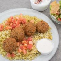 Falafel Platter Over Rice Vegetarian · Vegetarian. Deep fried vegetable patties made with chickpeas and spices. Served over basmati...