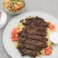 Grilled Beef Kafta Platter · Seasoned Ground beef grilled. Served over basmati rice with Greek salad, fattoush salad, and...