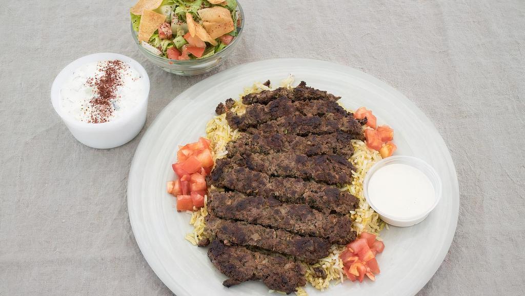 Grilled Beef Kafta Platter · Seasoned Ground beef grilled. Served over basmati rice with Greek salad, fattoush salad, and tzatziki sauce.