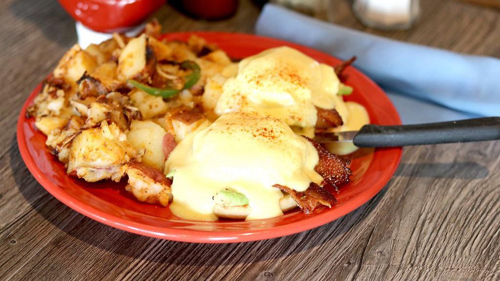 California · Appetizing poached eggs, avocado, applewood smoked bacon, and tomatoes on a toasted English muffin.