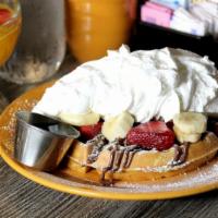 Nutella Waffle · Delicious Nutella, fresh strawberries, banana, topped whipped cream, and powdered sugar.