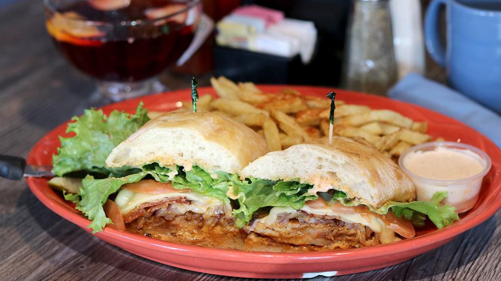 Cajun Chicken Sandwich · Spicy Cajun-style grilled chicken, lettuce, swiss cheese, tomato, Applewood smoked bacon, grilled red onions, and chipotle aioli.