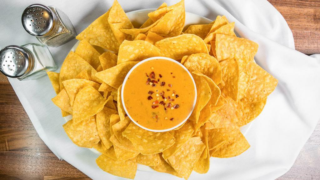 Chile Con Queso · Melty Green Chile and Cheese Dip. Served with Chips.