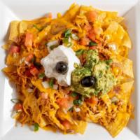 Super Nachos · Chips, cheese, beans, guacamole, sour cream, tomatoes, and onions.