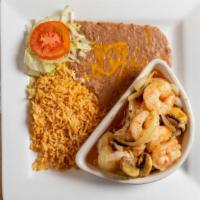 Camarones Al Mojo De Ajo · Shrimp sautéed in butter and garlic with mushrooms, onions, and spices. Served with rice, be...