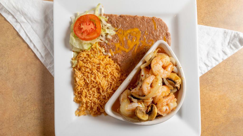Camarones Al Mojo De Ajo · Shrimp sautéed in butter and garlic with mushrooms, onions, and spices. Served with rice, beans, and tortillas.