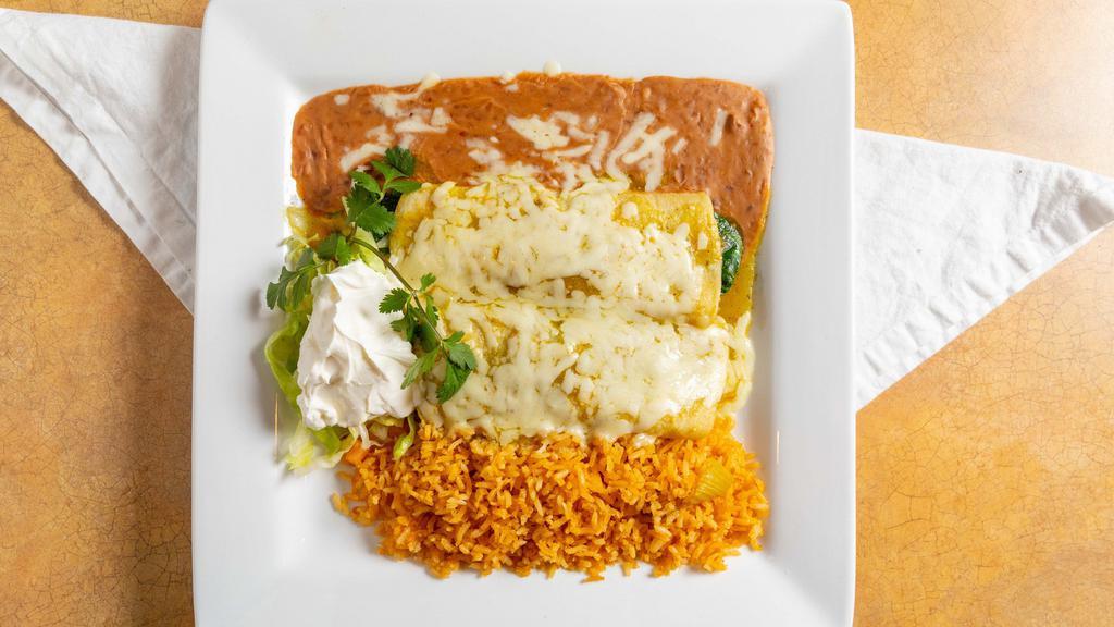 Spinach Enchiladas · Spinach sautéed with mushrooms, onions, tomatoes, and cilantro rolled into two corn tortillas. Smothered in tomatillo green sauce and topped with jack cheese. Served with sour cream, rice and beans.