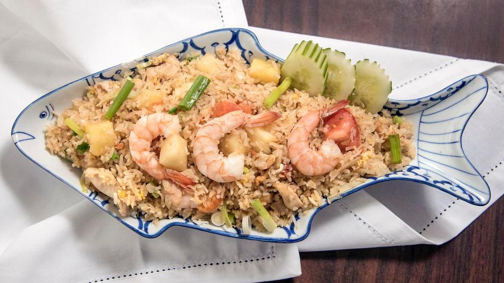 Pineapple Fried Rice · Thai jasmine rice stir-fried with your choice of protein, cashew nuts, pineapple, egg, onion and tomatoes. 