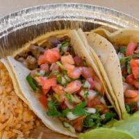 Two Carne Asada Tacos  · Served with rice and beans.