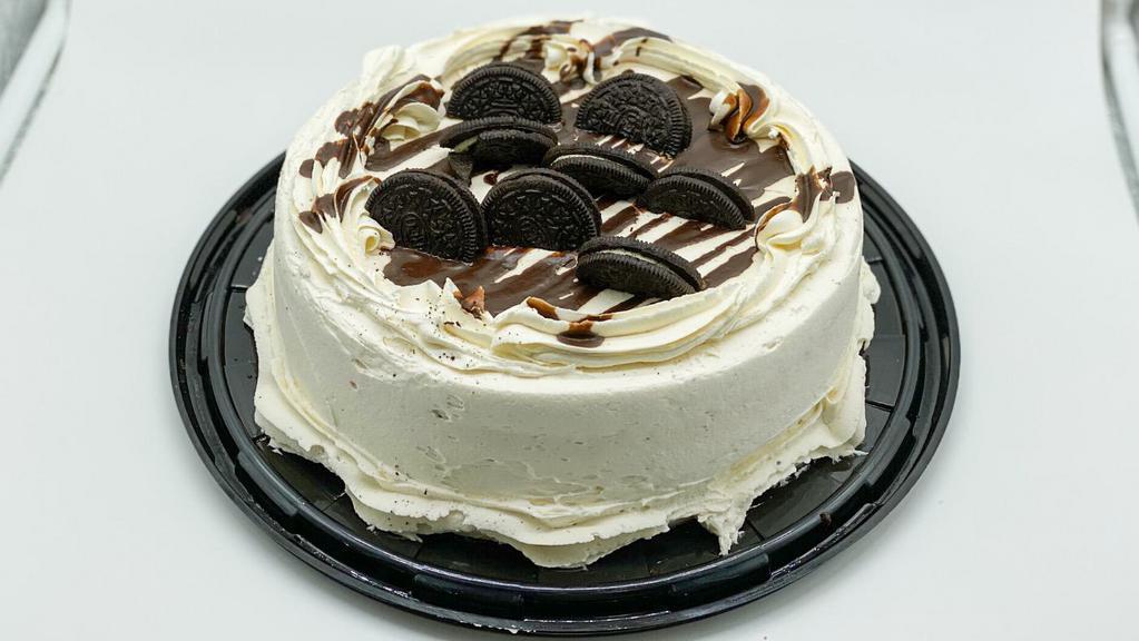 Oreo Cake · CHOCOLATE CAKE FILLED WITH BAVARIAN CREAM. COVERED WITH CREAM CHEESE FROSTING AND DECORATED WITH LIQUID CHOCOLATE AND OREO COOKIES.