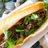 Banh Mi Pulled Pork · French baguette served with homemade butter, fried onion, cucumber, cilantro, jalapeno, and ...