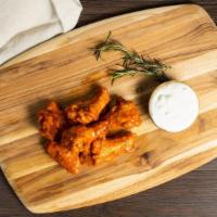 Wings For Winners · Chicken wings fried until perfectly golden served with celery & carrots, your choice of sauc...