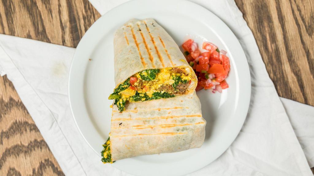 Breakfast Burrito · Vegan sausage and tofu with red onion, potatoes, roasted red pepper, kale and queso in a tortilla. Comes with a side of sour cream and salsa.