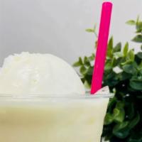 Piña Colada · Pineapple drink made with coconut milk topped with a scoop of pineapple coconut ice cream ov...