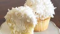 Coconut Cupcake · Our vanilla bean cake topped with coconut buttercream and rolled in toasted coconut and a do...