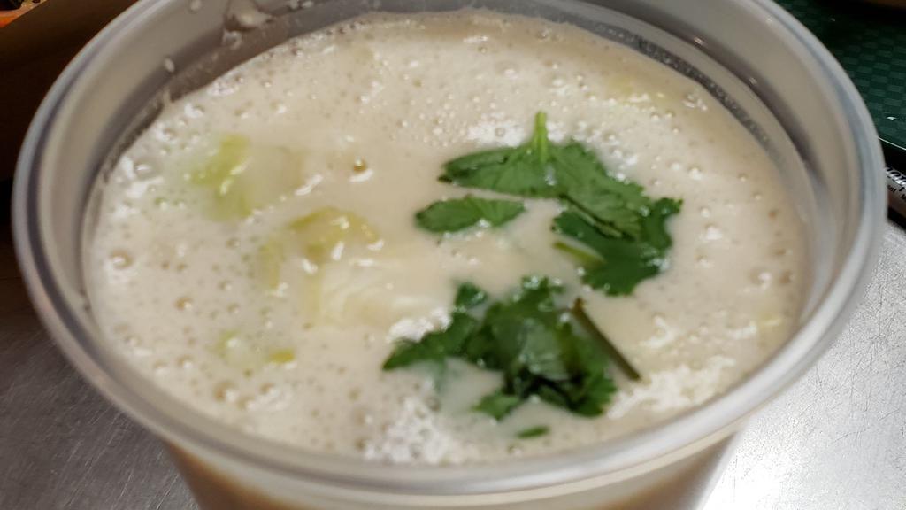 Tom Kha · Thai coconut soup with coconut milk, galangal, lemongrass, kaffir lime leaves, lime juice, fish sauce, mushrooms, and cabbage.