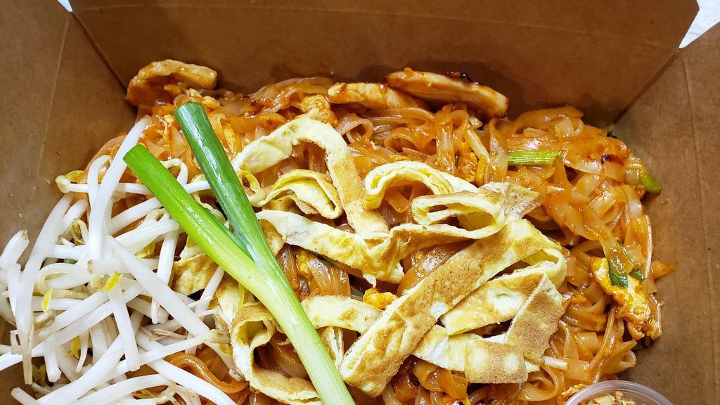 Pad Thai · Stir-fried thin rice noodle with pad Thai sauce, eggs, bean sprout, and Green onion served with bean sprout, ground peanut, green onion, and slice of lime.