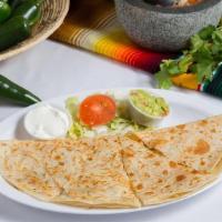 Quesadilla · Warm flour tortilla folded in half, filled with cheese and served with a side of sour cream ...