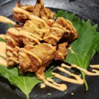 Chicken Karaage · Deep-fried seasoned chicken wings, served with daikon sprouts.