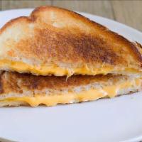 Grilled Cheese · Sharp cheddar melted and toasted between two thick slices of sourdough bread.