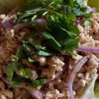Larb Gai · Gluten free. Ground chicken mixed with lime juice. enjoy wrapping with cabbage leaves.