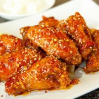 Chili Marinated Hot Wings (12) · Spicy. Fried hot wings tossed in a spicy, sweet garlic sauce. Served with a side of pickled ...