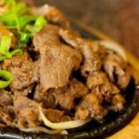 Bulgogi · Korean BBQ rib-eye marinated in bulgogi sauce. Served with sizzling hot stone pot rice and s...