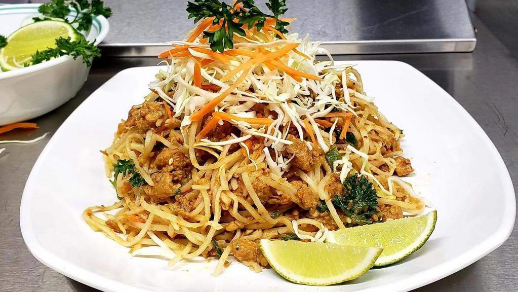Shan Noodles Salad · Shan traditional spiced curried chicken mixed with rice noodle, cilantro, cabbage, carrot, green onion, roasted crushed peanut (optional), garnished with house dressing and sprinkled with roasted sesame seeds. Served with crispy shrimp cracker.